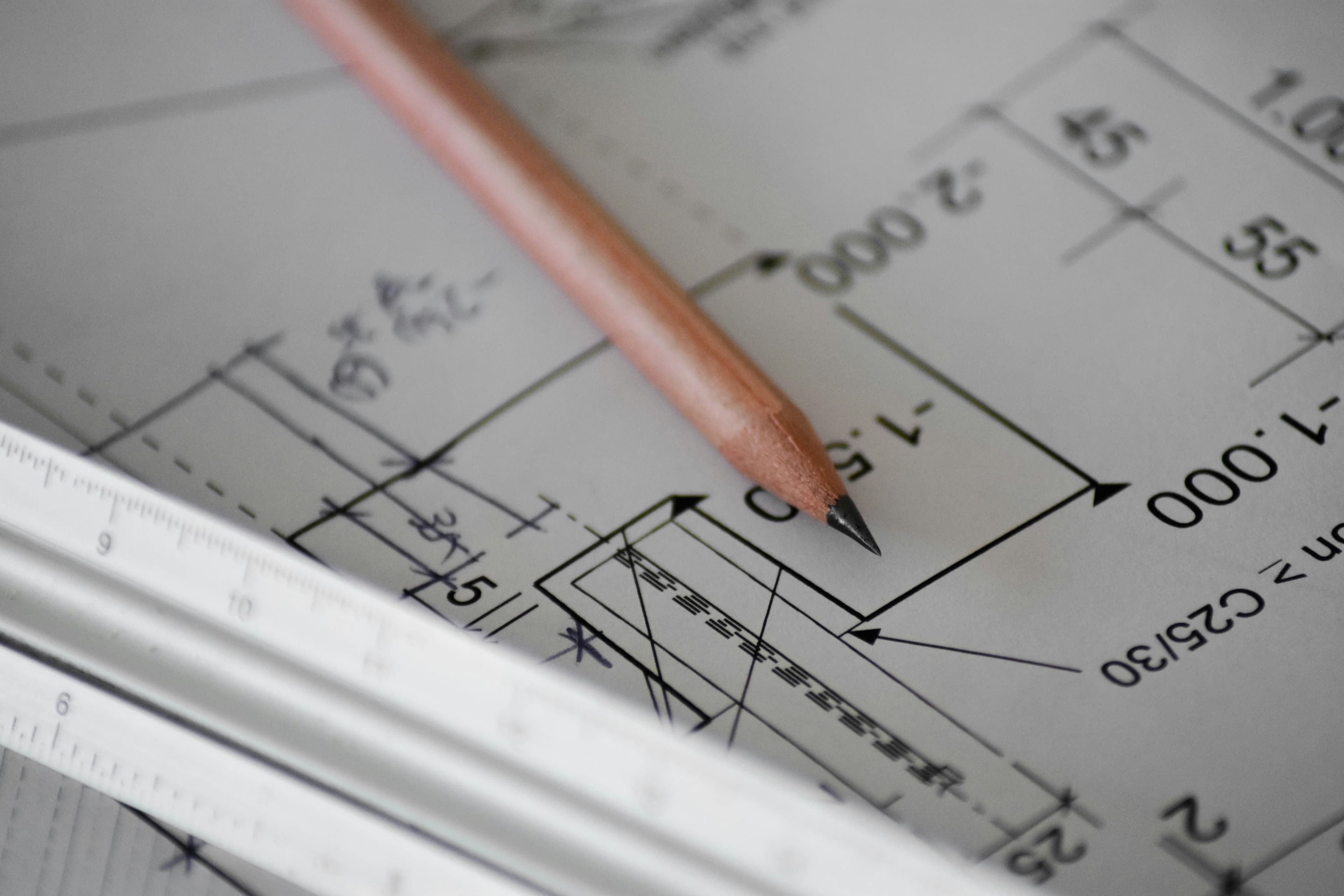 A technical drawing being marked up with a pencil